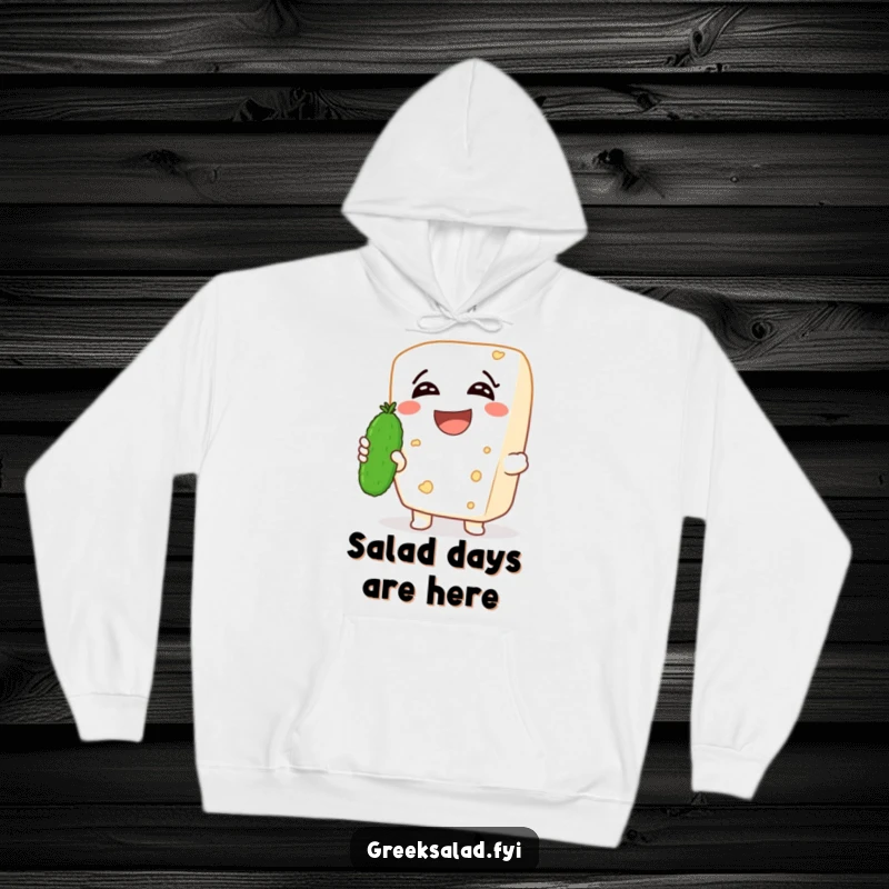 Funny hoodie showcasing a laughing feta cheese character holding a tiny cucumber, offering warmth and a boost of cheesy, humorous design.