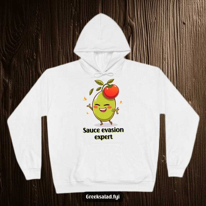 Funny olive character with a mischievous grin, comically dodging a flying tomato on a cozy hoodie, humorous foodie apparel.