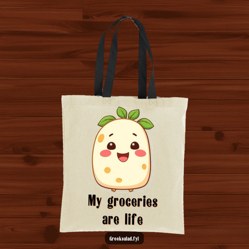 Funny tote bag featuring a smiling feta cheese character, a charming and practical accessory for carrying daily items with a cheesy twist.